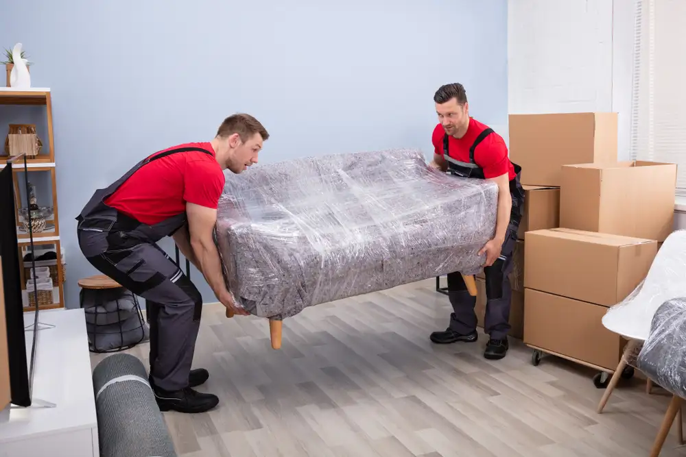 Efficient international moving team managing the loading and unloading of furniture with care.