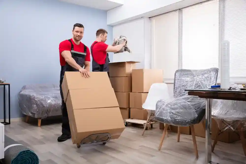 Professional office movers organizing and packing office furniture.